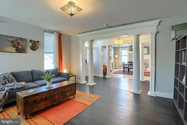 living room with baseboards, dark wood-style floors, and ornate columns