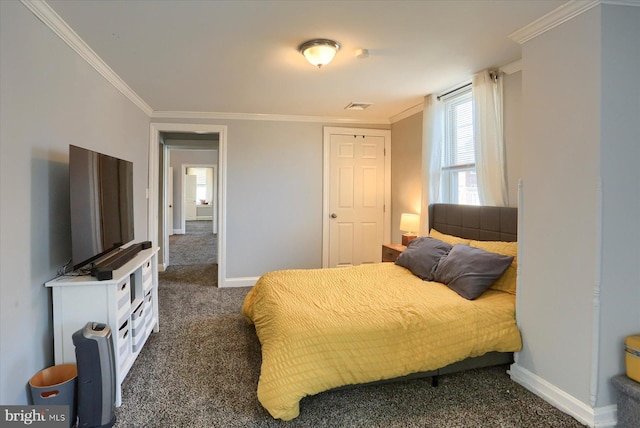 bedroom featuring dark colored carpet, visible vents, baseboards, and ornamental molding