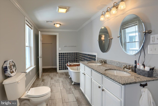 full bath featuring a soaking tub, visible vents, toilet, and a sink