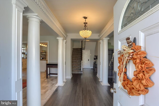 entrance foyer with stairs, decorative columns, baseboards, and dark wood-style flooring