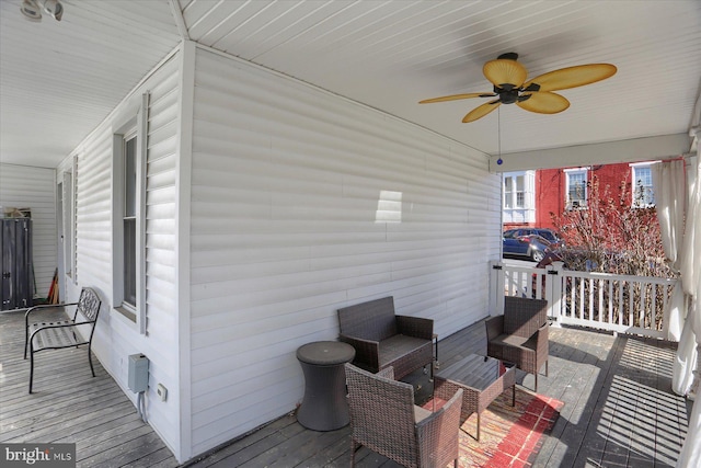 wooden terrace featuring outdoor lounge area and ceiling fan