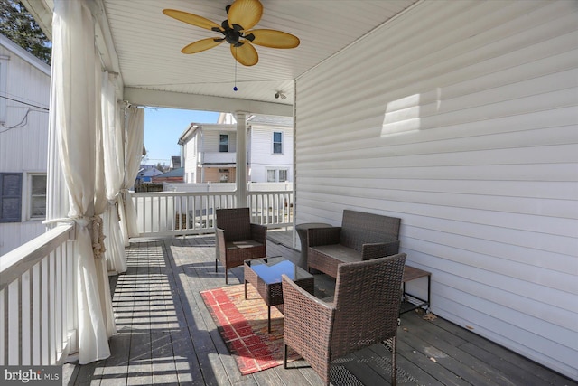 wooden deck featuring an outdoor living space and ceiling fan