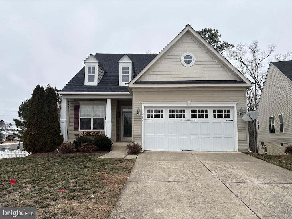 view of front facade featuring a front yard and a garage