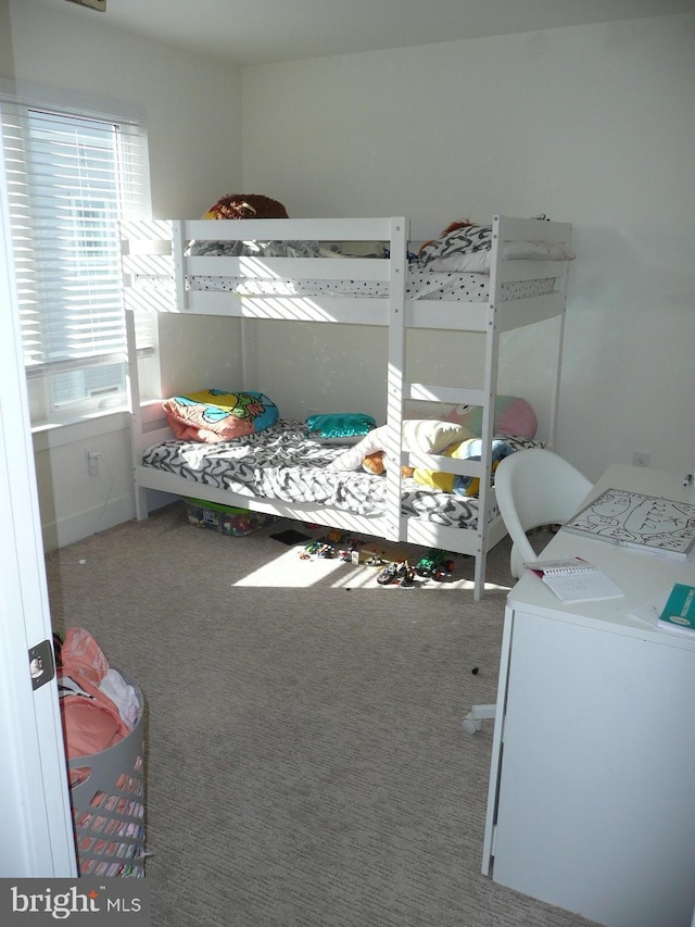 bedroom with carpet flooring and washer / clothes dryer