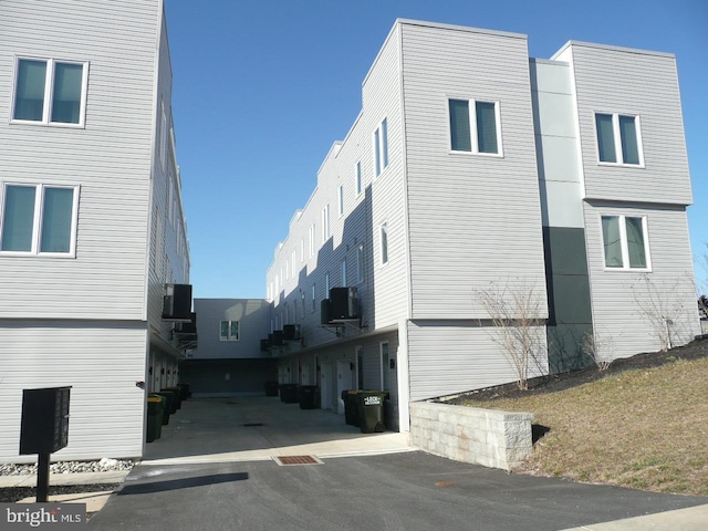 view of home's exterior with a garage and central AC unit