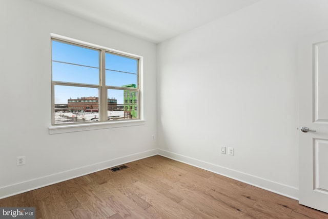 unfurnished room with light hardwood / wood-style flooring