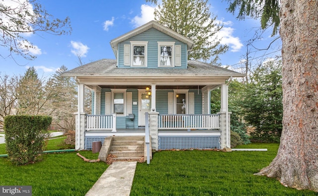 bungalow-style home featuring a front yard and covered porch