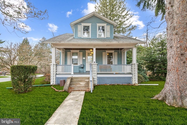 bungalow with a front lawn and covered porch