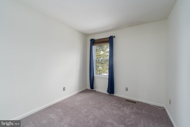 carpeted empty room with visible vents and baseboards