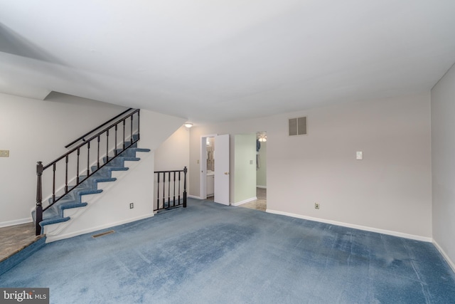 interior space featuring carpet flooring, visible vents, and baseboards