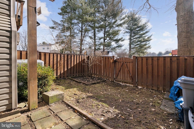 view of yard featuring fence and a gate