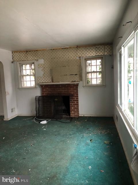 unfurnished living room with a fireplace