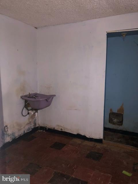 bathroom with sink and a textured ceiling