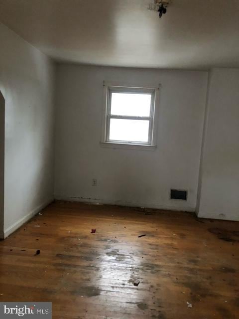 spare room featuring dark hardwood / wood-style flooring