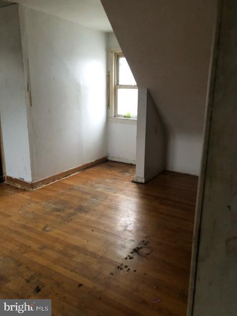 bonus room with wood-type flooring