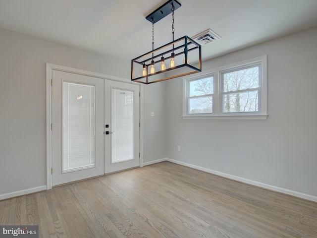 interior space with light hardwood / wood-style floors and french doors