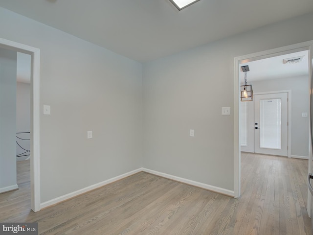 unfurnished room with light wood-type flooring