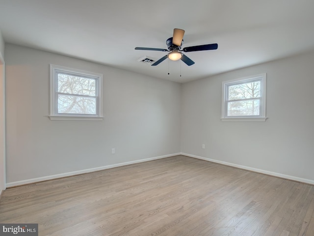 empty room featuring ceiling fan and light hardwood / wood-style floors