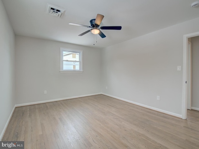 spare room with light wood-type flooring and ceiling fan