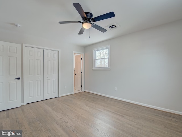 unfurnished bedroom featuring ceiling fan, light hardwood / wood-style floors, and a closet