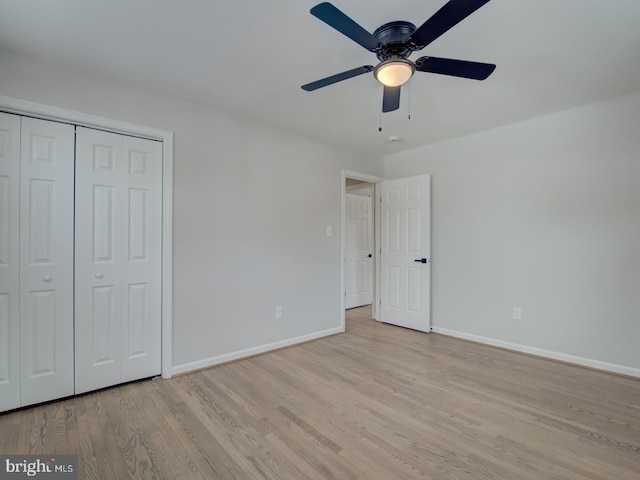 unfurnished bedroom featuring ceiling fan, light hardwood / wood-style floors, and a closet