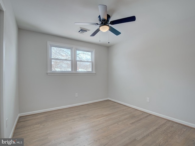 spare room featuring light wood-type flooring and ceiling fan