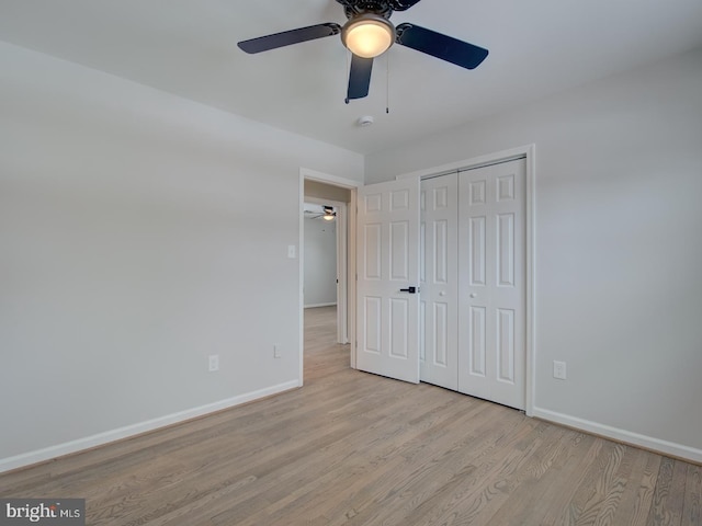 unfurnished bedroom with a closet, ceiling fan, and light hardwood / wood-style flooring