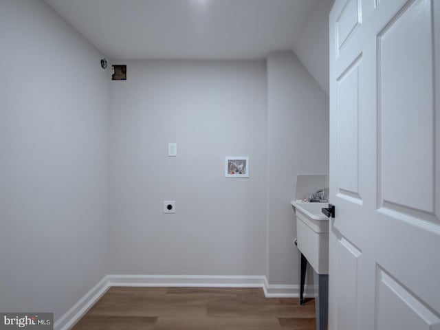 washroom featuring electric dryer hookup, hookup for a washing machine, and dark hardwood / wood-style floors