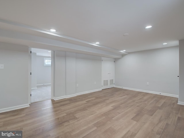 basement with light hardwood / wood-style floors