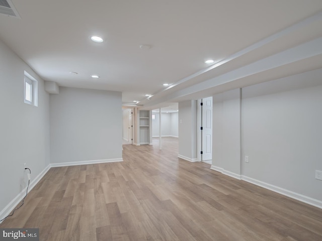 basement with light hardwood / wood-style flooring