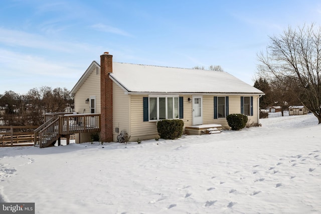 view of snow covered back of property