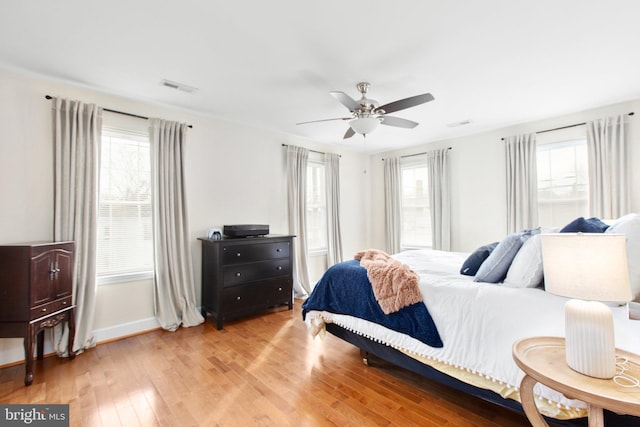 bedroom with ceiling fan and light hardwood / wood-style flooring