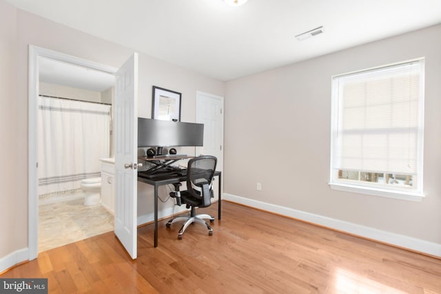 office area with light hardwood / wood-style flooring