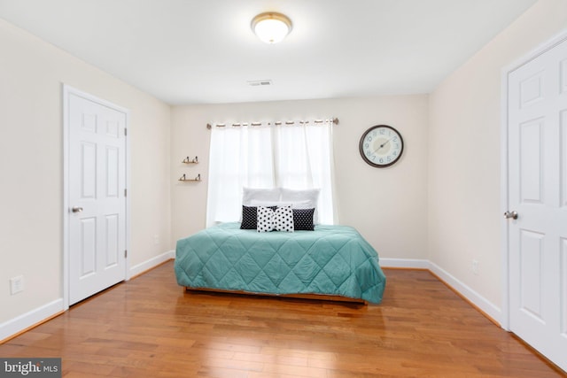 bedroom with hardwood / wood-style floors