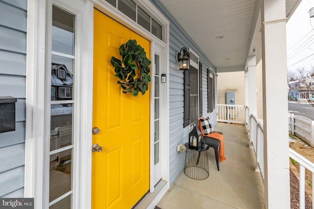 view of exterior entry with a porch