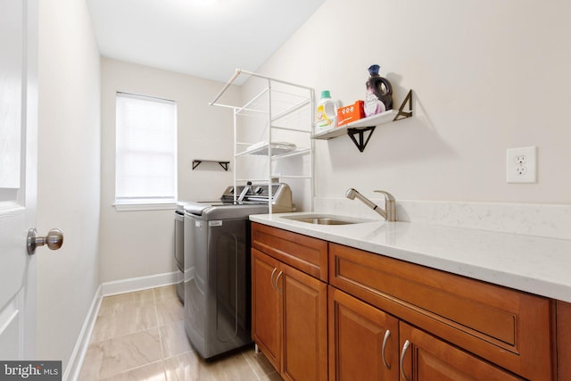 laundry room with cabinets, sink, and washing machine and clothes dryer