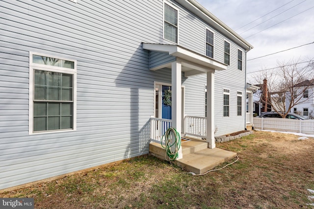 view of exterior entry with a lawn