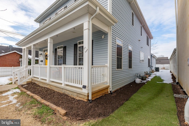 view of side of home featuring central AC and covered porch