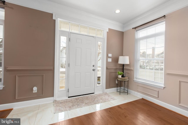 tiled entrance foyer featuring ornamental molding