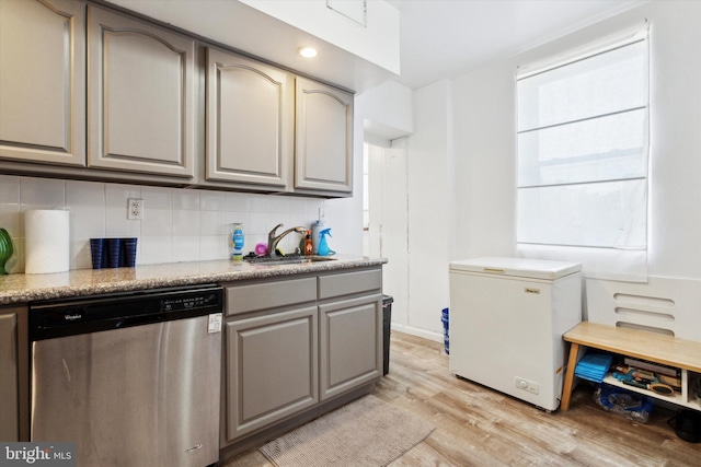 kitchen with dishwasher, refrigerator, sink, light hardwood / wood-style flooring, and tasteful backsplash