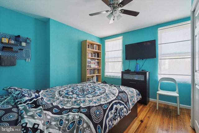 bedroom with ceiling fan and hardwood / wood-style flooring