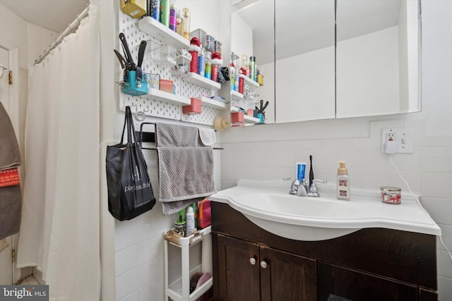 bathroom with tile walls, backsplash, and vanity