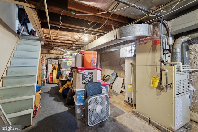 basement with gas water heater and heating unit