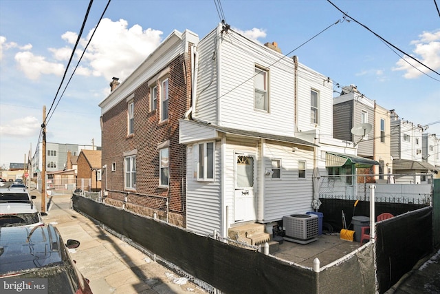 rear view of property with central AC unit