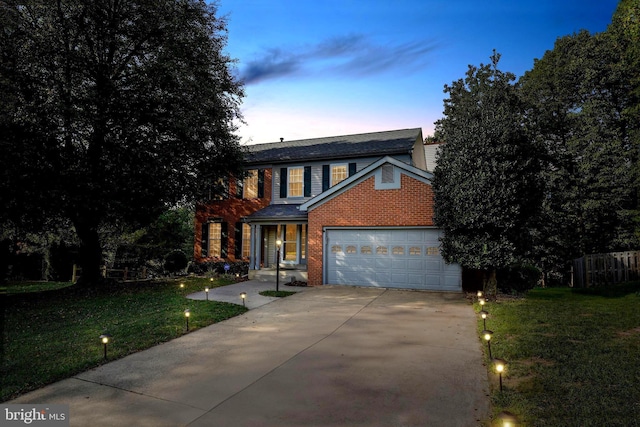 view of front facade featuring a garage and a yard