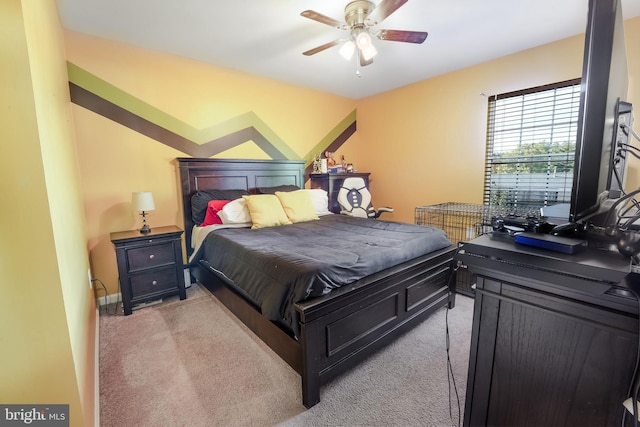 bedroom with ceiling fan and light carpet