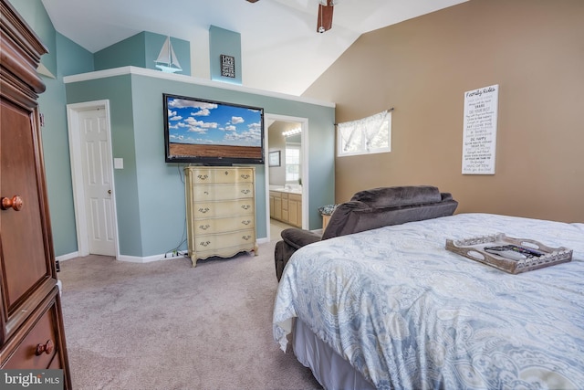 carpeted bedroom with ceiling fan, ensuite bath, and vaulted ceiling