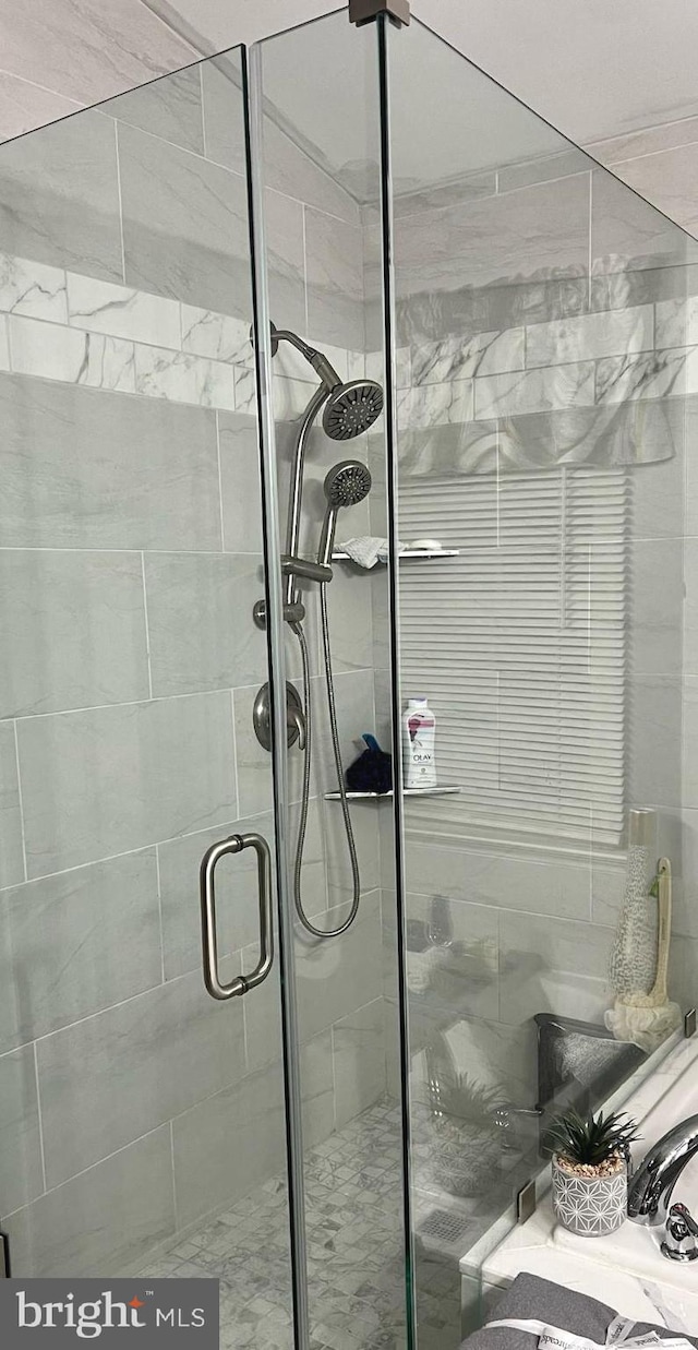 bathroom with a shower with door