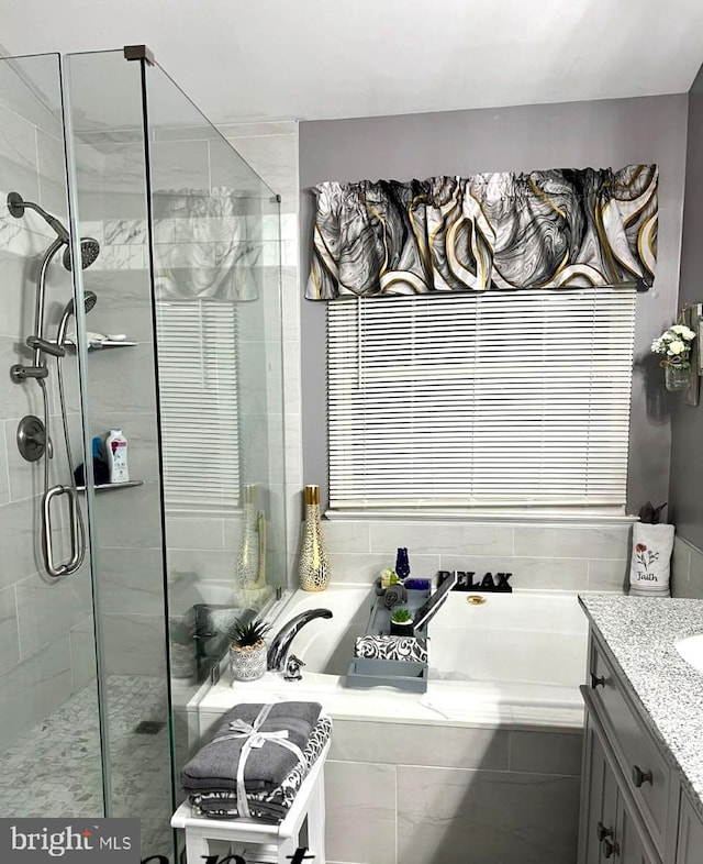 bathroom featuring vanity and plus walk in shower