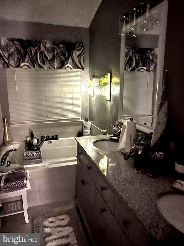 bathroom with vanity and a tub